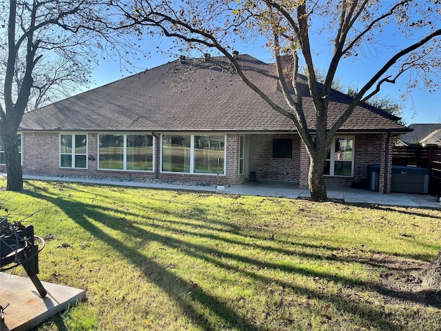 rear view of property with a patio area and a yard