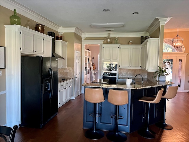 kitchen featuring a breakfast bar, dark wood-type flooring, a notable chandelier, and appliances with stainless steel finishes