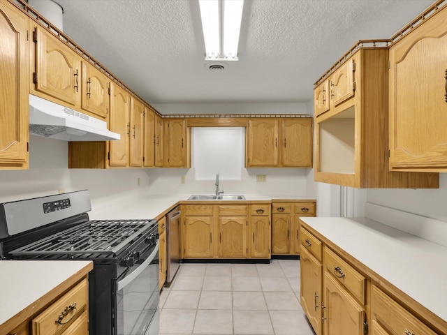 kitchen with sink, gas stove, a textured ceiling, light tile patterned floors, and stainless steel dishwasher