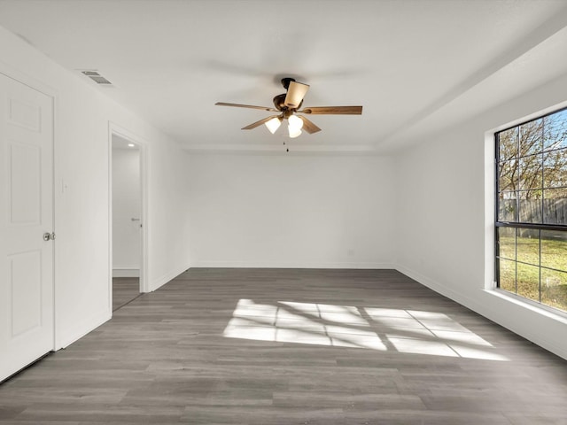 spare room featuring dark hardwood / wood-style floors and ceiling fan