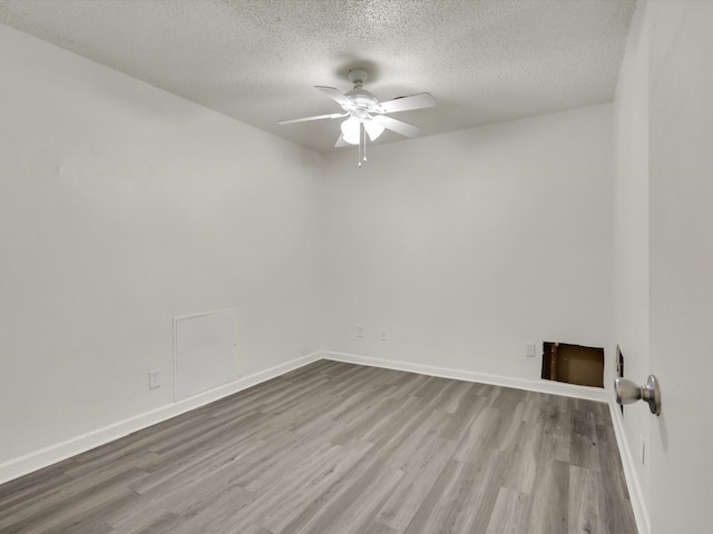 spare room featuring a textured ceiling, ceiling fan, and light hardwood / wood-style flooring