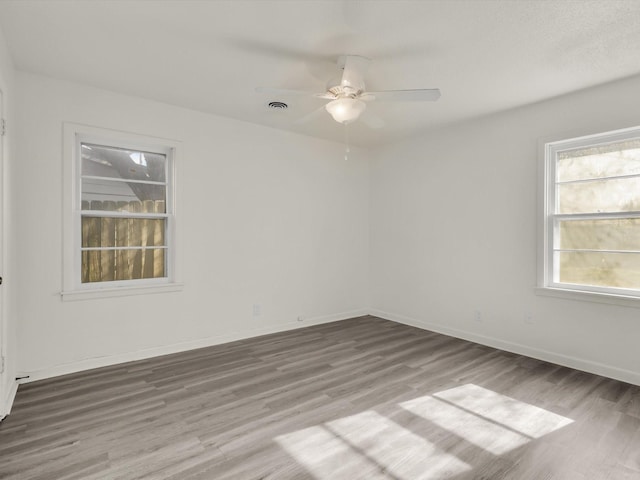 empty room with wood-type flooring and ceiling fan