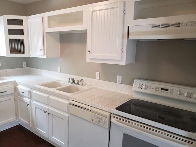 kitchen featuring white appliances, ventilation hood, sink, white cabinetry, and tile counters