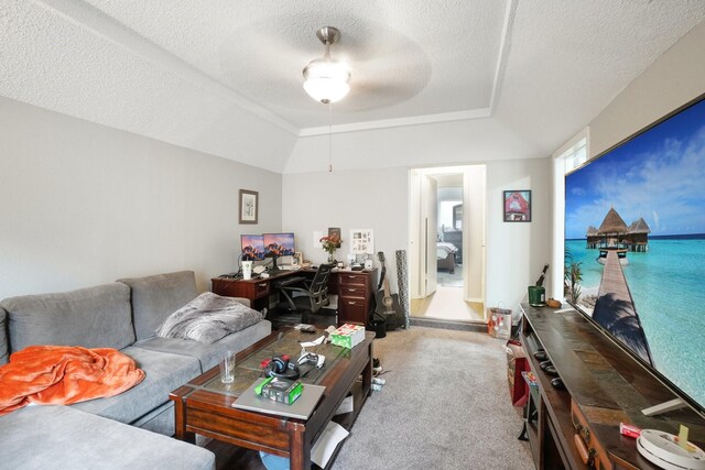 living room featuring ceiling fan, light colored carpet, and a textured ceiling