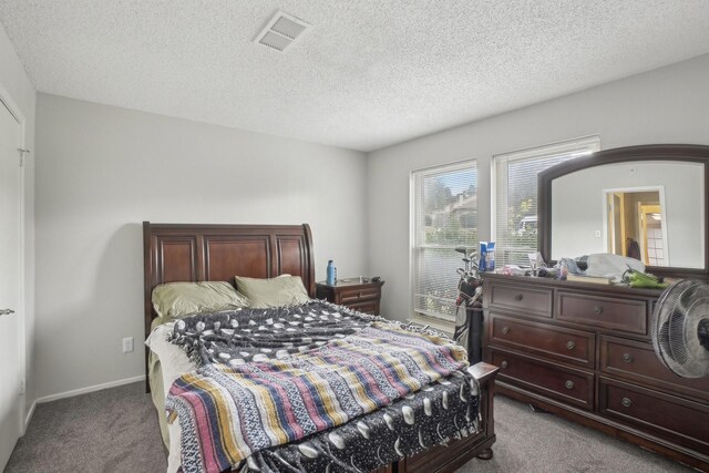 bedroom featuring carpet floors and a textured ceiling