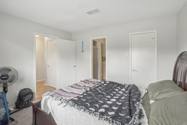 bedroom with carpet flooring and a textured ceiling