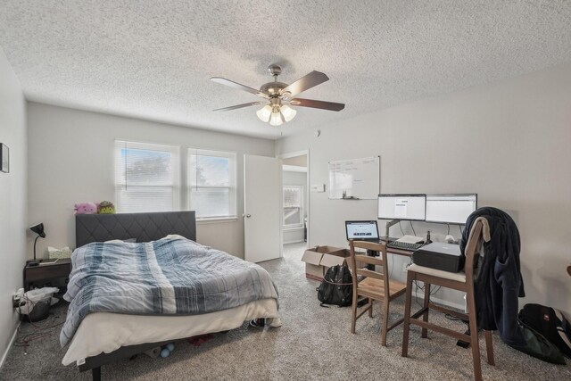 carpeted bedroom featuring a textured ceiling and ceiling fan