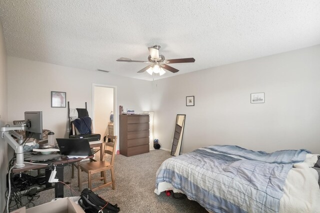 bedroom featuring carpet flooring, a textured ceiling, and ceiling fan