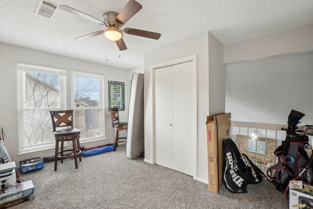 rec room with carpet flooring, a textured ceiling, and ceiling fan