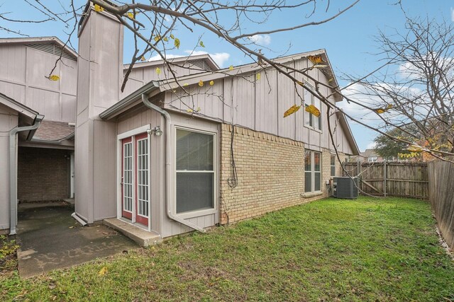 view of property exterior with a lawn and central AC unit