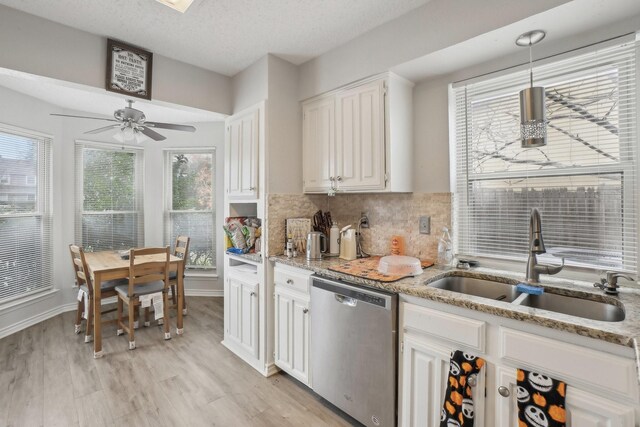 kitchen featuring white cabinetry, dishwasher, light wood-type flooring, and sink