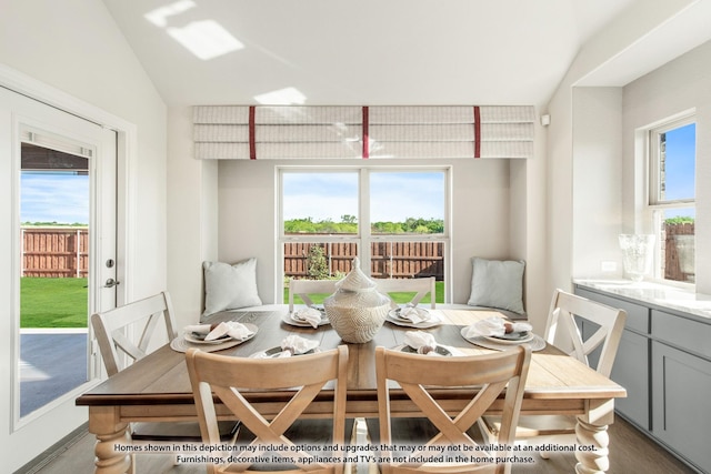 dining area featuring a healthy amount of sunlight and lofted ceiling