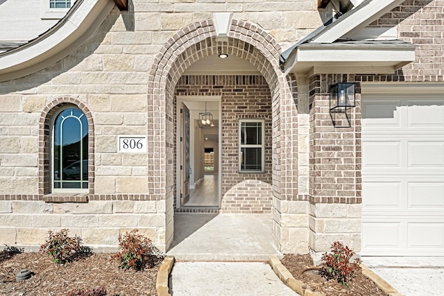 806 Willowbanks Dr, Josephine, TX 75173 - doorway to property featuring an attached garage, brick siding, and stone siding