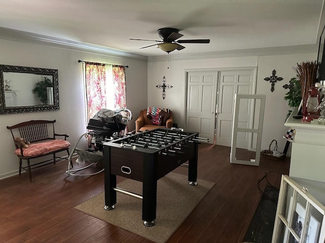 game room with crown molding, dark hardwood / wood-style flooring, and ceiling fan