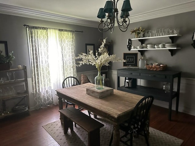 dining space with an inviting chandelier, dark wood-type flooring, and ornamental molding