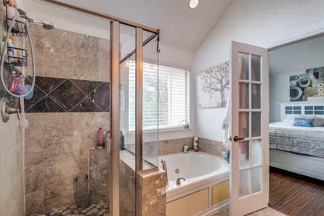 bathroom featuring wood-type flooring, plus walk in shower, and vaulted ceiling