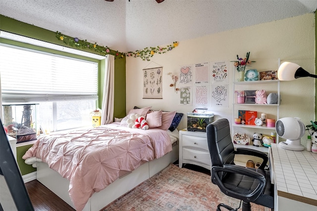 bedroom with hardwood / wood-style floors and a textured ceiling