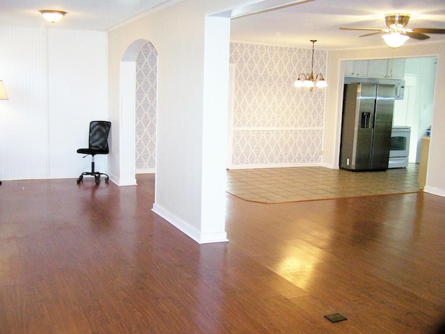 unfurnished room with ornamental molding, dark hardwood / wood-style floors, and ceiling fan with notable chandelier