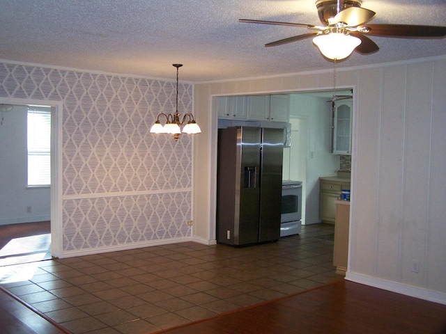 kitchen featuring a textured ceiling, ornamental molding, stainless steel fridge, dark hardwood / wood-style flooring, and white range with electric cooktop