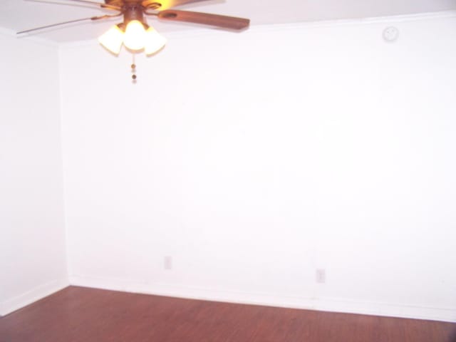 unfurnished room with dark hardwood / wood-style floors and ceiling fan