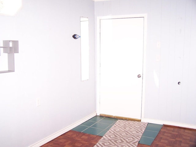 entryway with dark parquet flooring