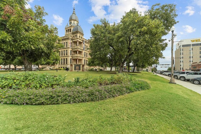 view of property's community with a lawn