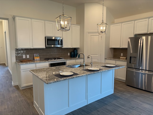 5204 Edge Way, Denton, TX 76226 - kitchen with appliances with stainless steel finishes, a sink, decorative backsplash, white cabinetry, and vaulted ceiling