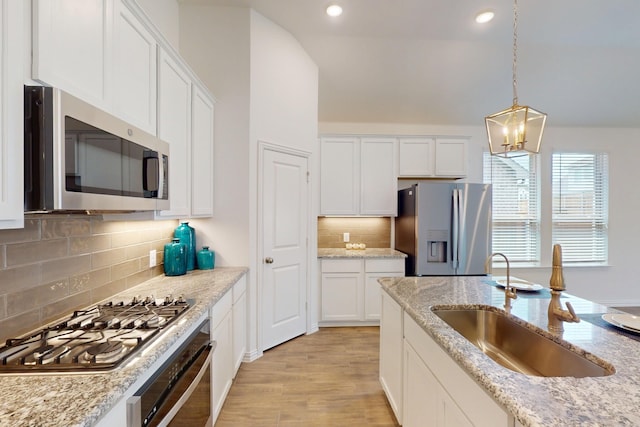 5204 Edge Way, Denton, TX 76226 - kitchen with stainless steel appliances, a sink, white cabinets, and recessed lighting