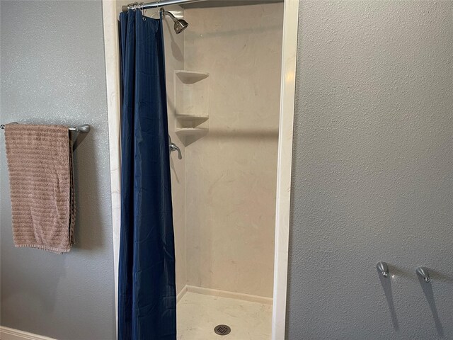 bathroom with a shower with shower curtain