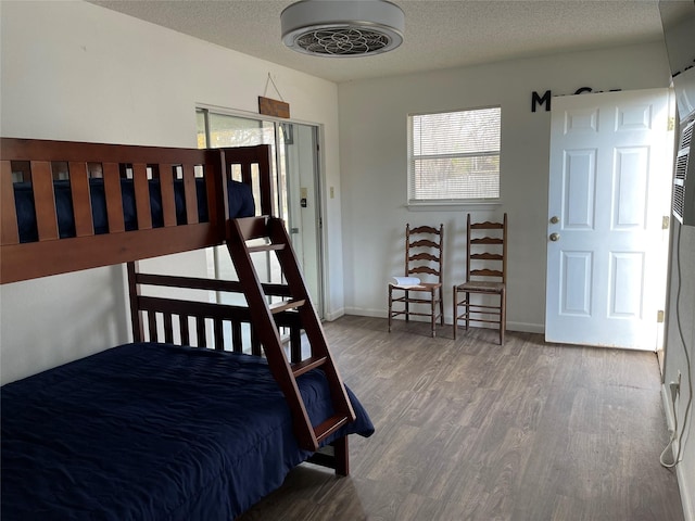 bedroom with hardwood / wood-style floors and a textured ceiling