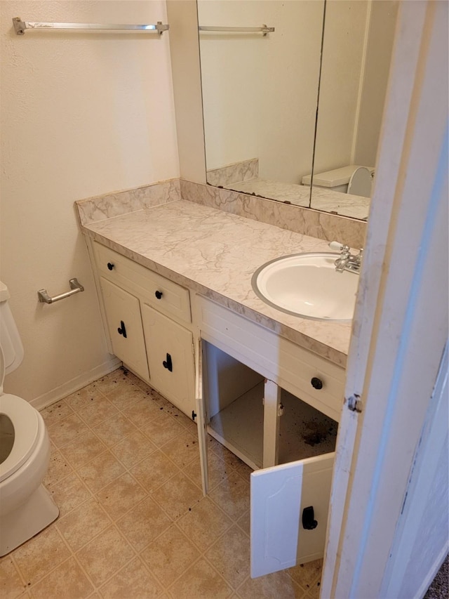 bathroom featuring vanity and toilet