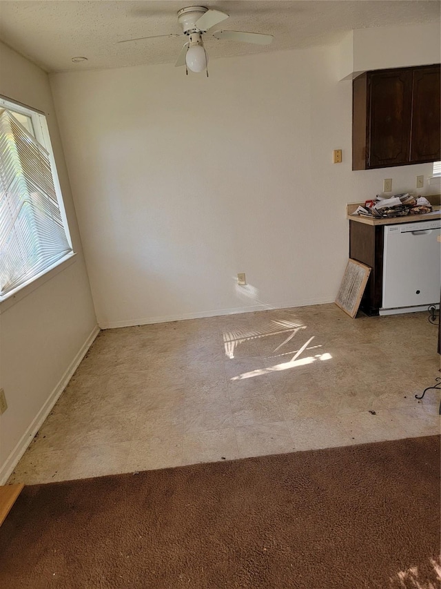 unfurnished dining area featuring light carpet and ceiling fan