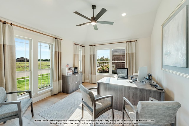 home office featuring ceiling fan, vaulted ceiling, and light hardwood / wood-style flooring