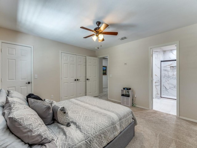 carpeted bedroom featuring ceiling fan, connected bathroom, and a closet