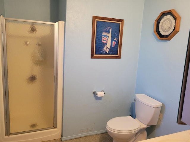 bathroom with toilet and a shower with shower door