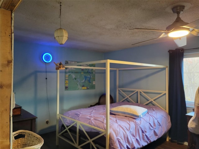 bedroom with ceiling fan and a textured ceiling