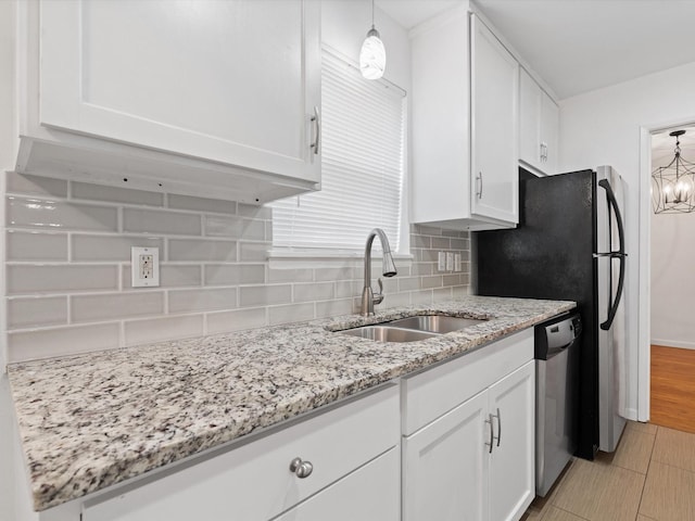 kitchen with dishwasher, white cabinetry, and sink