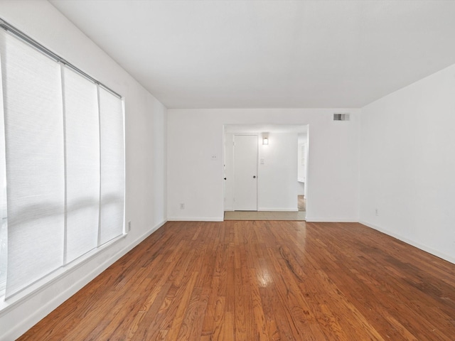 empty room with hardwood / wood-style floors