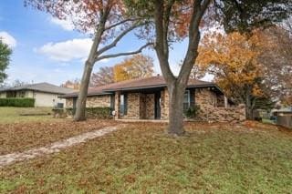 ranch-style home with a front yard