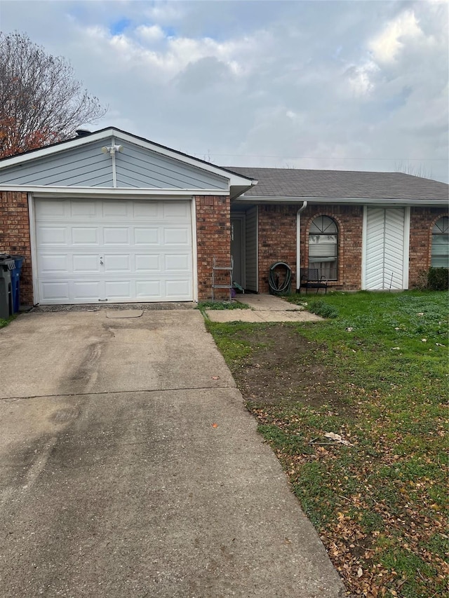 ranch-style house with a garage and a front yard