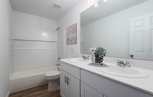 full bathroom featuring hardwood / wood-style flooring, vanity, toilet, and washtub / shower combination