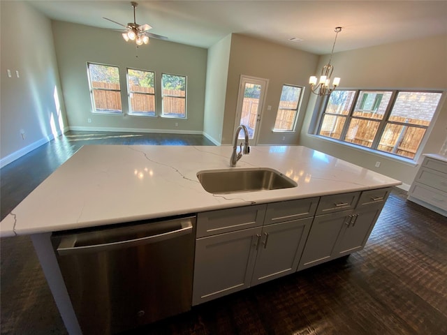 kitchen with dishwasher, ceiling fan with notable chandelier, sink, gray cabinets, and decorative light fixtures