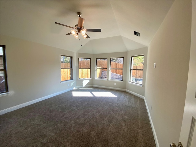 unfurnished room with ceiling fan, carpet floors, a wealth of natural light, and vaulted ceiling