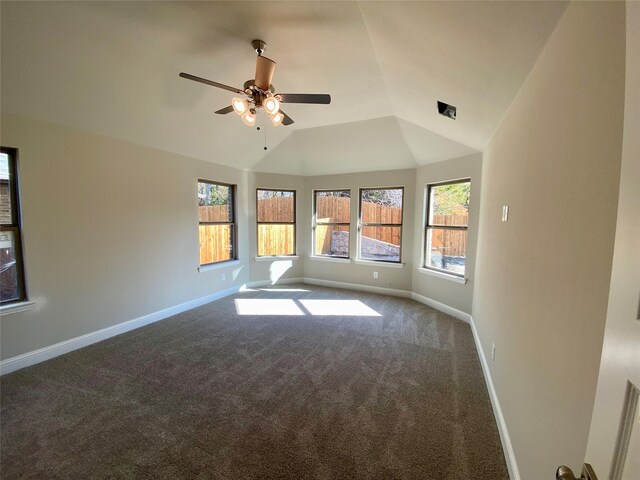 spare room featuring lofted ceiling, carpet, baseboards, and ceiling fan