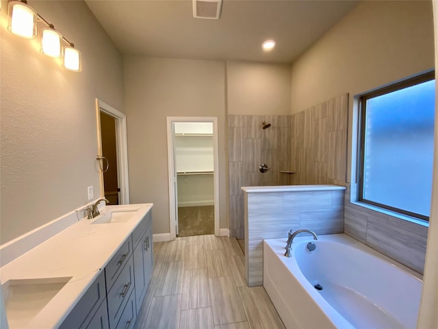 bathroom with shower with separate bathtub and vanity