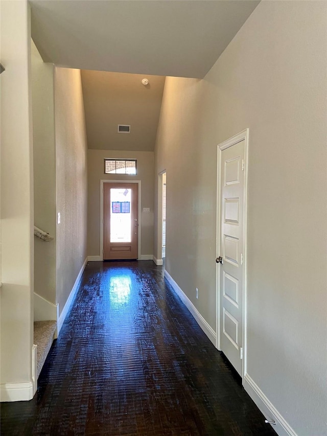 entryway featuring dark hardwood / wood-style flooring and high vaulted ceiling