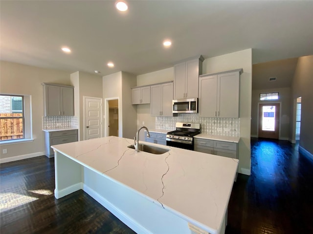 kitchen featuring sink, stainless steel appliances, a wealth of natural light, and dark wood-type flooring