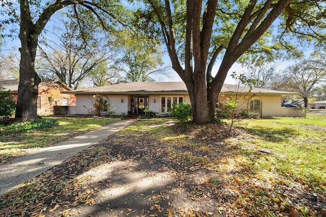 ranch-style house with a front lawn