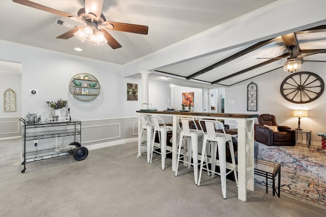 dining room with decorative columns, ceiling fan, lofted ceiling with beams, and ornamental molding