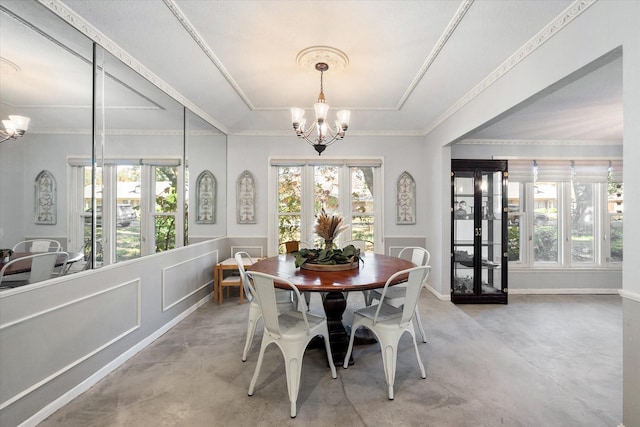 dining space with a healthy amount of sunlight, french doors, crown molding, and a chandelier